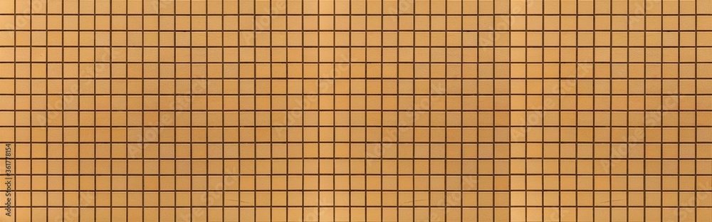 Panorama of Yellow or brown ceramic wall and floor tiles abstract background. Design geometric mosaic texture for the decoration of the bedroom. Panorama of Yellow or brown ceramic wall and floor tiles abstract background. Design geometric mosaic texture for the decoration of the bedroom.