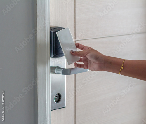 Hand Holding Key card Hotel room access.