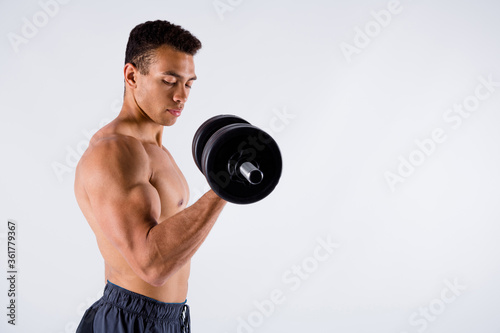 Profile photo of handsome hot macho sportsman dark skin guy naked chest warming up exercise focused lift heavy dumbbell lifter wear shorts isolated white color background