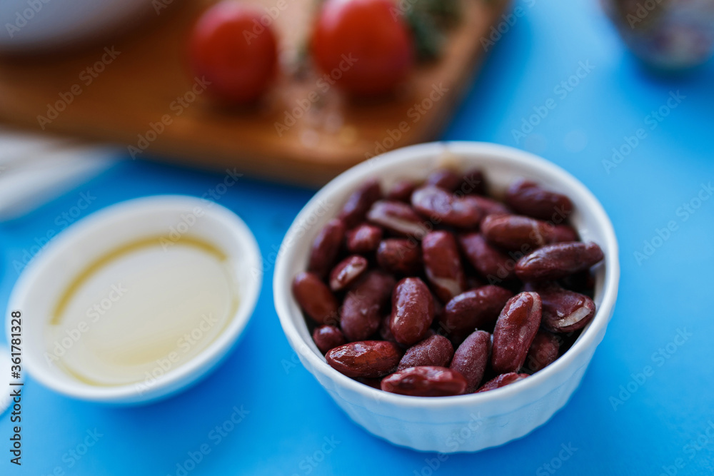 red bean in a plate, closeup. vegetables in the background in blur red bean in a plate, closeup. vegetables in the background in blur