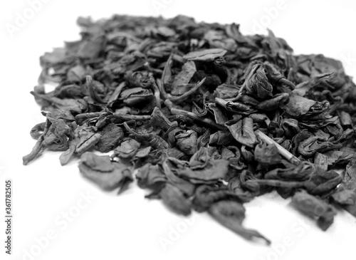 Dry green tea isolated on white with blur effect in black and white.
