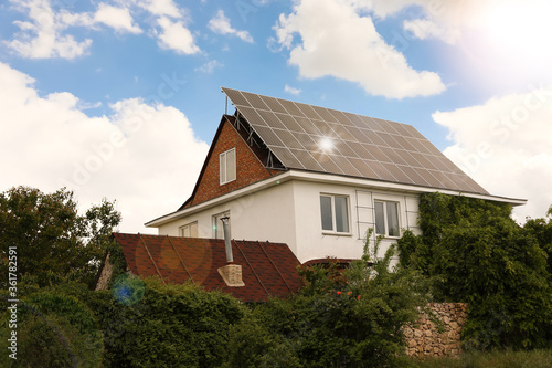 Wallpaper Mural Building with installed solar panels on roof. Alternative energy source Torontodigital.ca