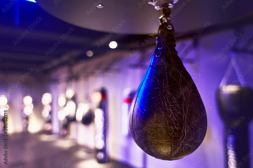 Black punching bag in boxing gym Black punching bag in boxing gym