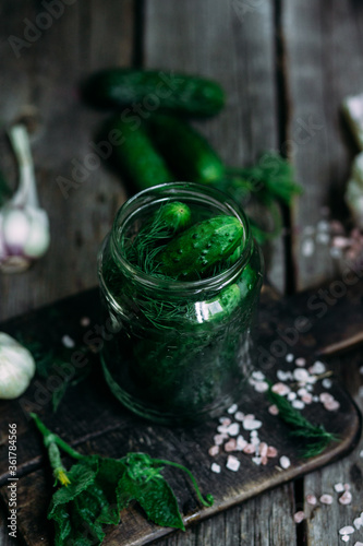 Fototapeta Naklejka Na Ścianę i Meble -  Recipe for pickling cucumbers. Jar with cucumbers on a wooden table