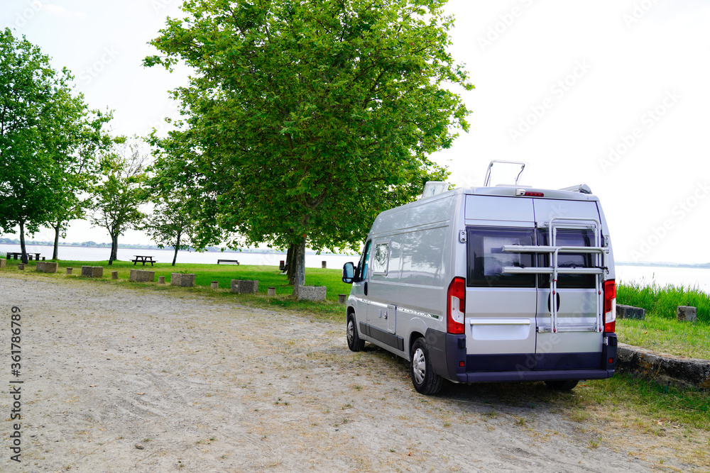 Motorhome RV campervan parked on a river side beach for night Motorhome RV campervan parked on a river side beach for night