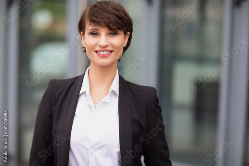 a smiling businesswoman posing outdoors