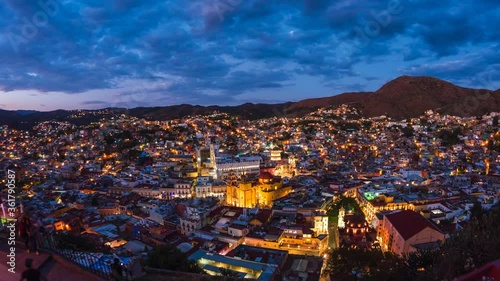 Guanajuato City, Mexico, day to night timelapse view of cityscape including historical landmark Basilica of Our Lady of Guanajuato and surrounding mountains. photo