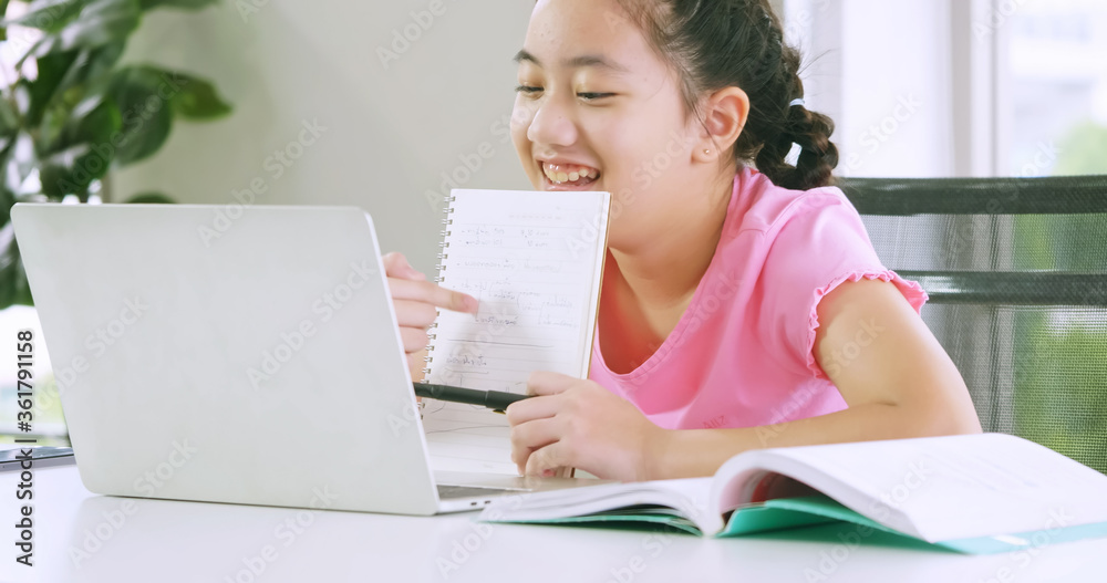 A girl studying online distance learning while quarantine at home. A girl studying online distance learning while quarantine at home.