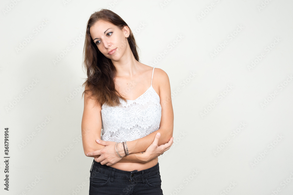 Portrait of young beautiful woman thinking with arms crossed Portrait of young beautiful woman thinking with arms crossed