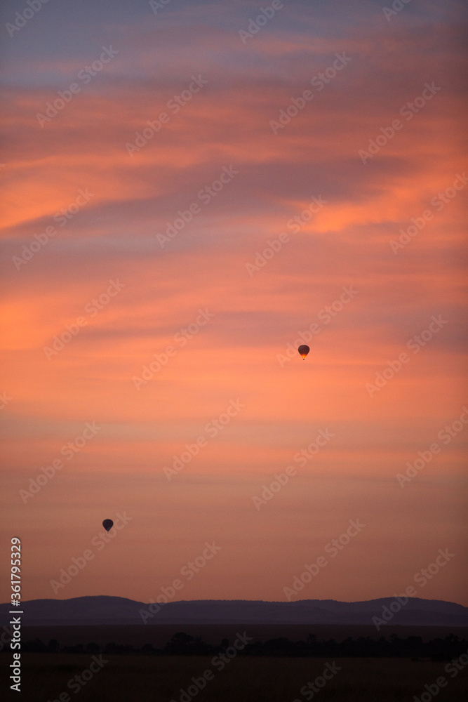 Hot air ballons in the sky during sunsrise at Masai Mara, Kenya