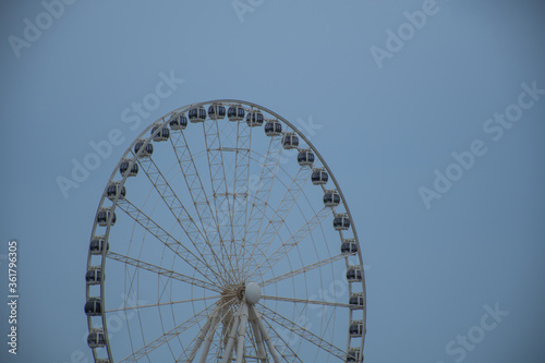 A big wheel ride at the Abu Dhabi Marina across a blue sky
