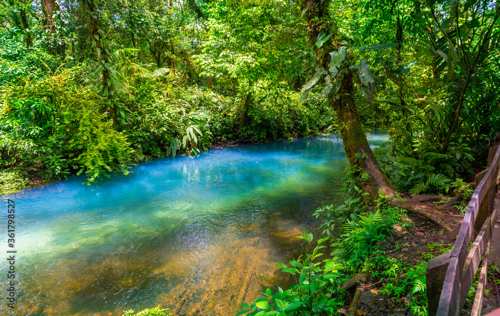Rio Celeste with turquoise, blue water. Connection of two rivers and chemical reaction, water become blue - turquoise. Tenorio national park Costa Rica. Central America. Rio Celeste with turquoise, blue water. Connection of two rivers and chemical reaction, water become blue - turquoise. Tenorio national park Costa Rica. Central America.