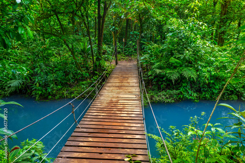 Rio Celeste with turquoise, blue water and small wooden bridge Tenorio national park Costa Rica. Central America.