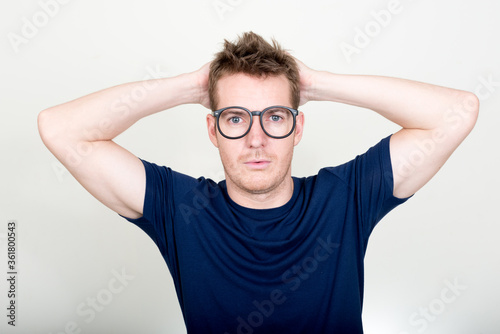Portrait of handsome man with eyeglasses looking confused