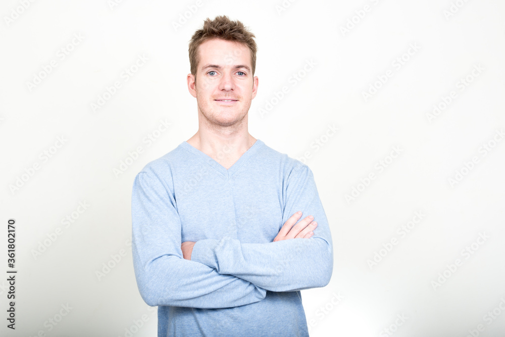 Portrait of happy handsome man smiling with arms crossed Portrait of happy handsome man smiling with arms crossed