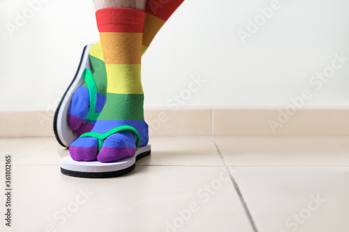 Detail of a man's feet with coloured LGBT socks and beach sandal photo