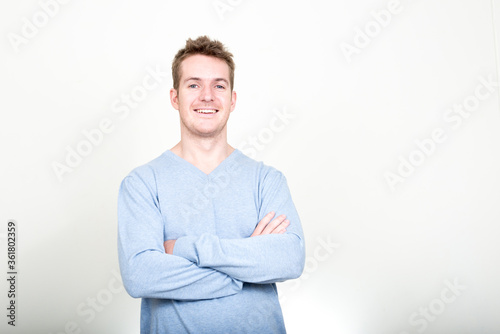 Portrait of happy handsome man laughing with arms crossed © Ranta Images