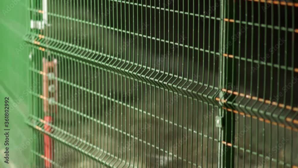 Perimeter security fencing system, razor wire fence with lighting at night, welded wire mesh fence line.