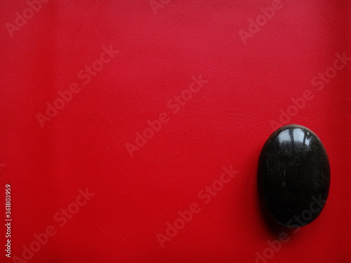 energetic black rock on red background
