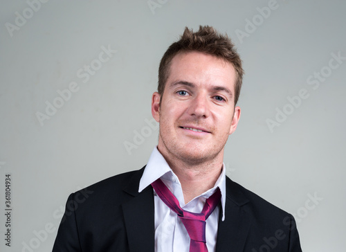 Face of happy handsome businessman in suit smiling