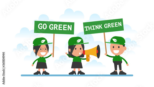 Group of people hold signs "Go green" and "Think green".
