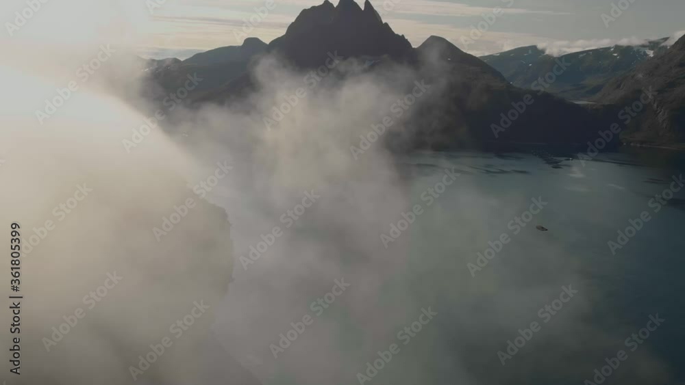 Aerial top view on the mountains ridge with clouds. Adventure journey traveling outdoor in Norway active vacation concept. Segla mountain, Senja, Norway.