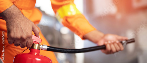 authorities fire man hand presses the trigger extinguisher available in  emergencies conflagration damage background. Safety photo