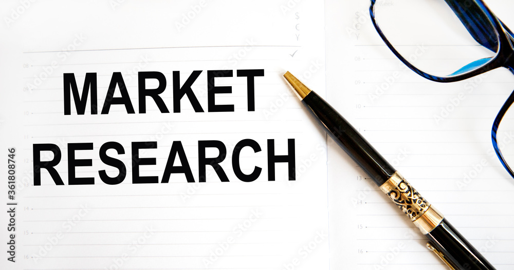 In the note book is an inscription of the market study, next to the glasses. In the note book is an inscription of the market study, next to the glasses.