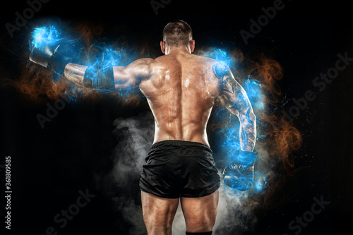 Athlete bodybuilder in blue energy lights. Boxing man posing on black background. Sporty guy male . Fitness muscled man. Sport concept © Mike Orlov