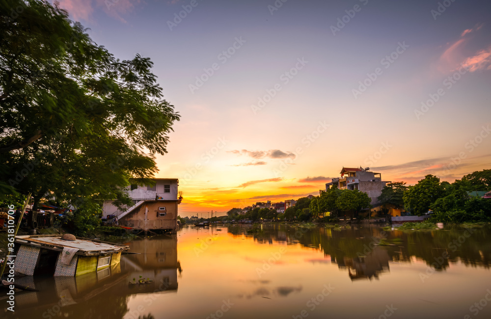Hai Phong, Vietnam Sep 2015 sunset at Tam Bac river bank with mirror water surface Hai Phong, Vietnam Sep 2015 sunset at Tam Bac river bank with mirror water surface