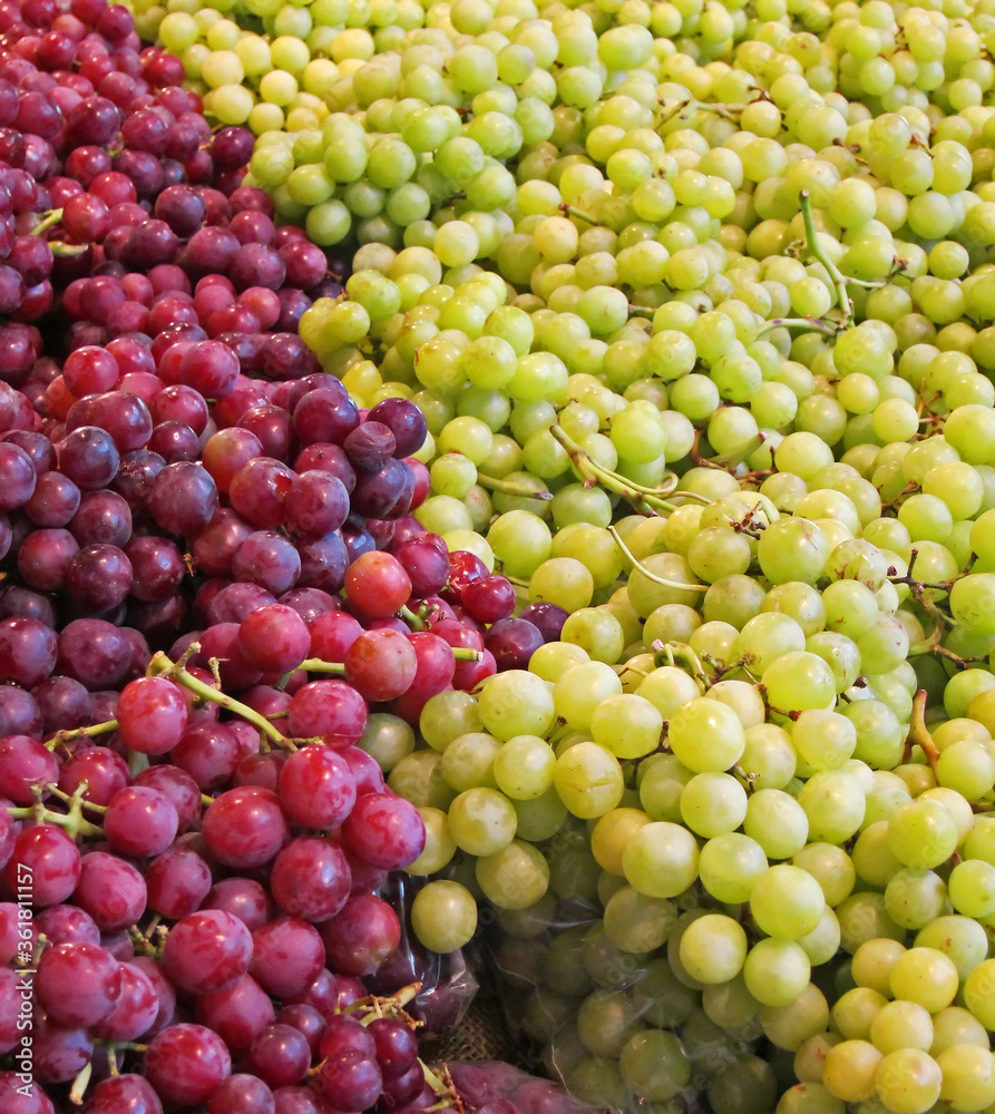 This is a large amount of green and red seedless grapes, displayed together in this fruit produce image.