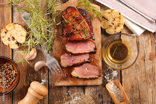 roasted duck breast with herb and sauce photo