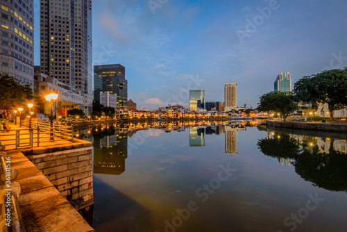 Fototapeta Naklejka Na Ścianę i Meble -  Singapore 2019, iconic view from Singapore river to Marina Bay Sands and Central Business District. Blue hour reflection on the water during sunrise sunset