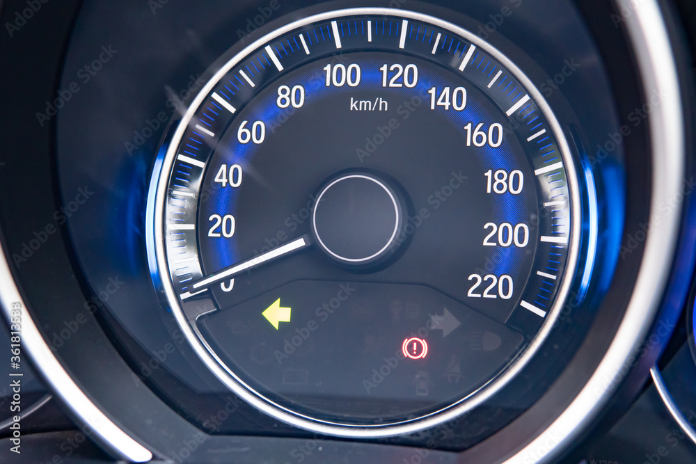 close-up on car dashboard and warning icon