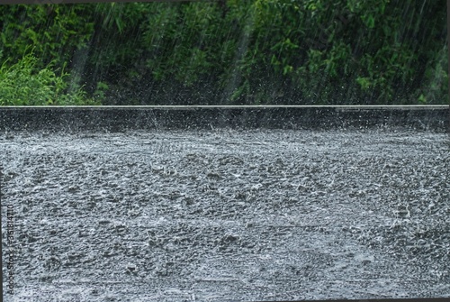 Heavy rain on a black flat roof