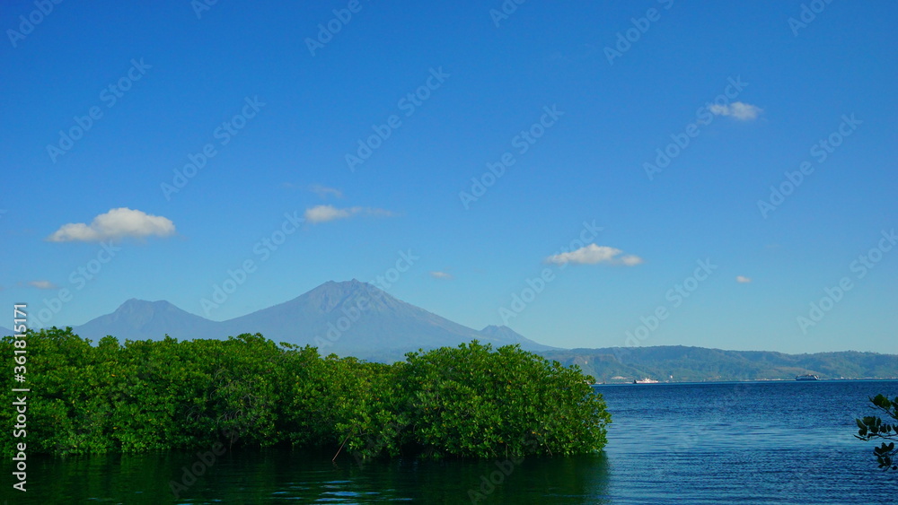 A view from Bali strait to Java island. Bali Strait is a stretch of water separating Java and Bali while connecting the Indian Ocean and the Bali Sea. 