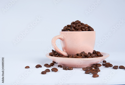 Coffee beans in a cup on a white background