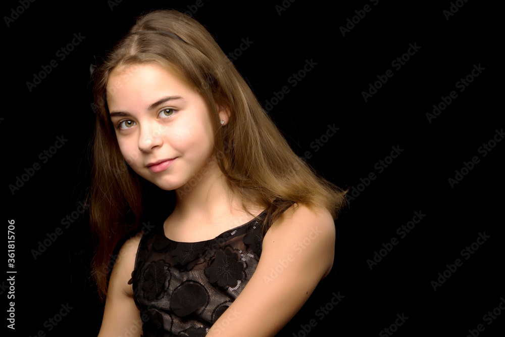 Close-up.Portrait of a cute little girl on a black background. Close-up.Portrait of a cute little girl on a black background.