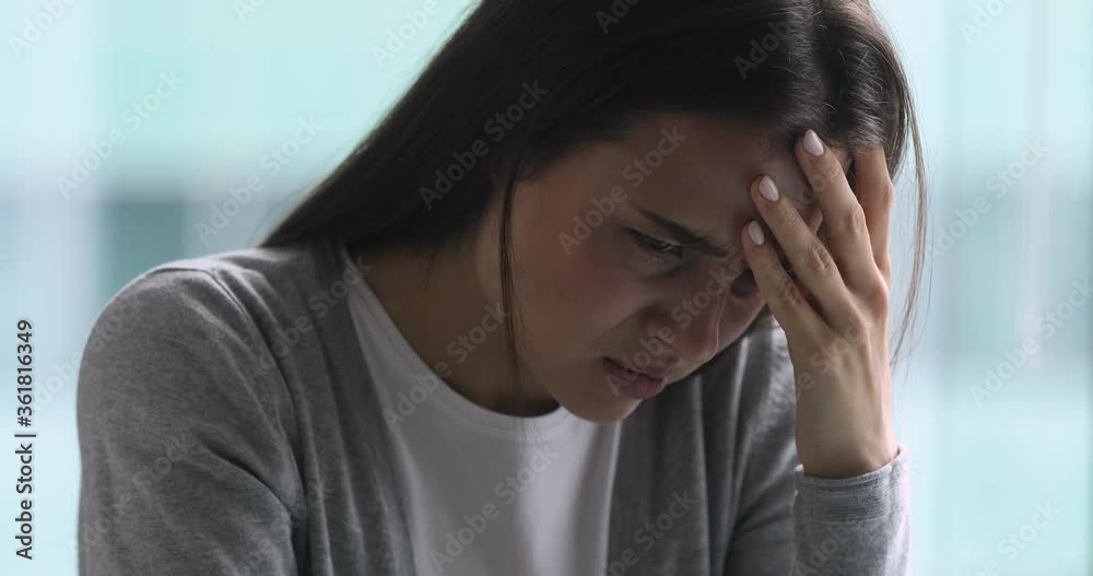 Upset sick young woman coping with terrible headache feel migraine, stressed tired girl frustrated suffer from pain ache pressure touching aching sore head at home office concept, face close up view Upset sick young woman coping with terrible headache feel migraine, stressed tired girl frustrated suffer from pain ache pressure touching aching sore head at home office concept, face close up view