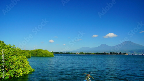 A view from Bali strait to Java island. Bali Strait is a stretch of water separating Java and Bali while connecting the Indian Ocean and the Bali Sea. 