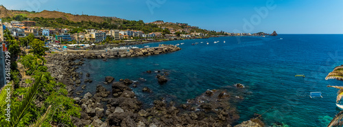 The bay, harbour, and promenade of Acicastello, Sicily viewed from the Norman castle in summer