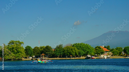 A view from Bali strait to Java island. Bali Strait is a stretch of water separating Java and Bali while connecting the Indian Ocean and the Bali Sea. 