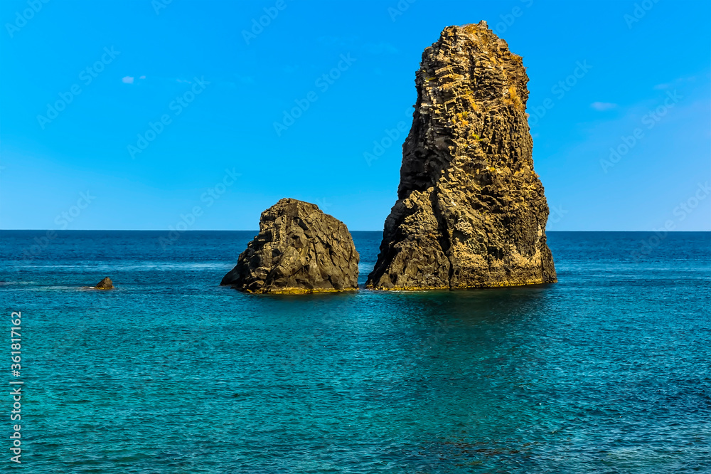 Two Basalt Stacks offshore at Aci Trezza, Sicily in summer