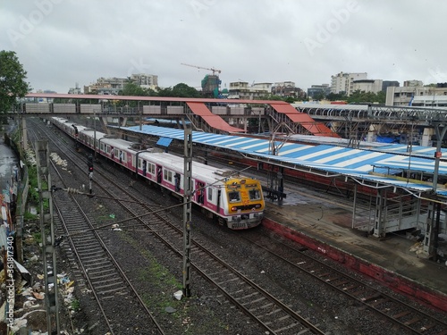 Mumbai, Maharashtra/India- June 30 2020:  Fast local train travelling on the railway track.