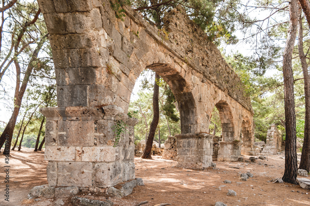 Ruins of aqueduct of ancient Phaselis city. Famous architectural landmark, Kemer district, Antalya province. Turkey.