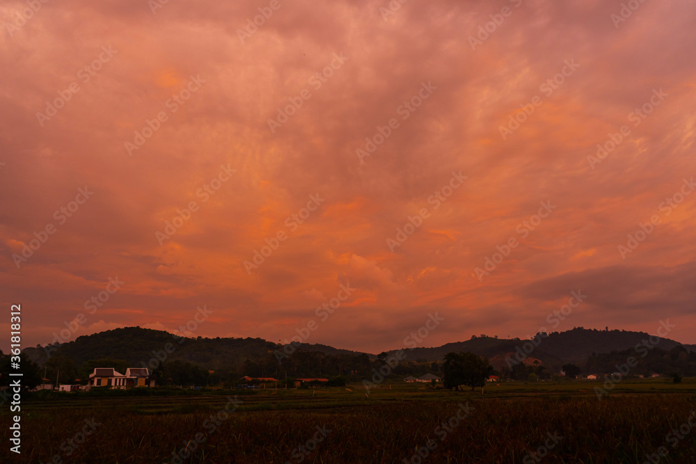 unusually beautiful fiery red tropical sunset in the mountains.