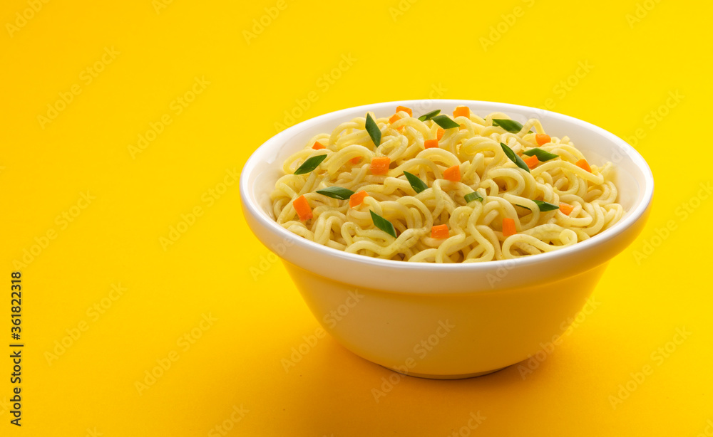 Bowl of instant noodles isolated on yellow background Bowl of instant noodles isolated on yellow background