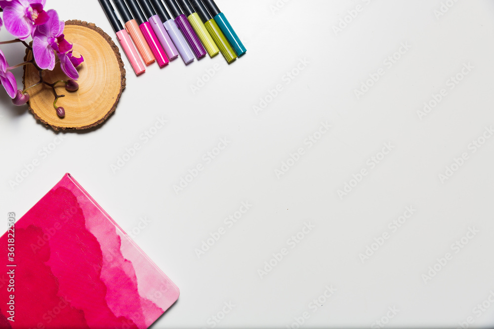 Art supplies on a white desk shot from high angle. Creative workplace concept