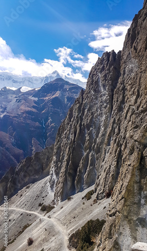 A dangerous passage along the landslide area on the way to Tilicho Base Camp, Annapurna Circus, Himalayas, Nepal. Dry and desolated landscape. Steep and sharp slopes. Extreme trekking