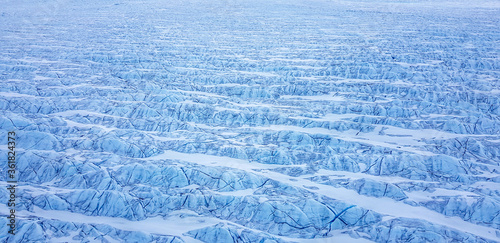 Wide aerial of glacier in greenland with glacial rivers and lakes